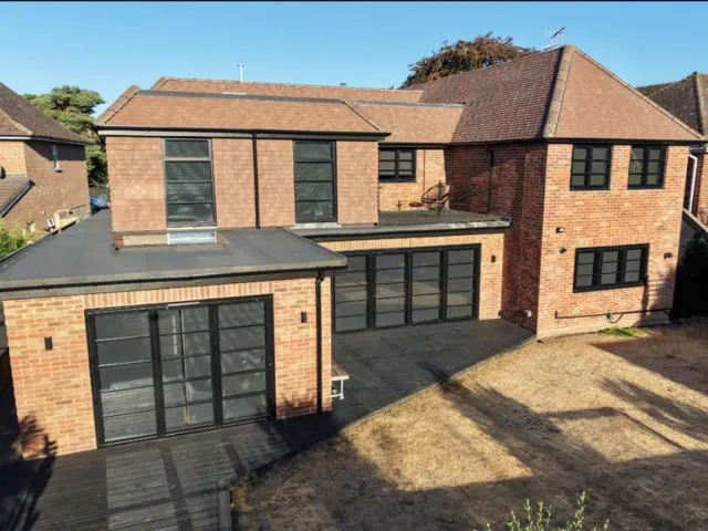 A finished Build and Co double storey rear extension with black framed glazing