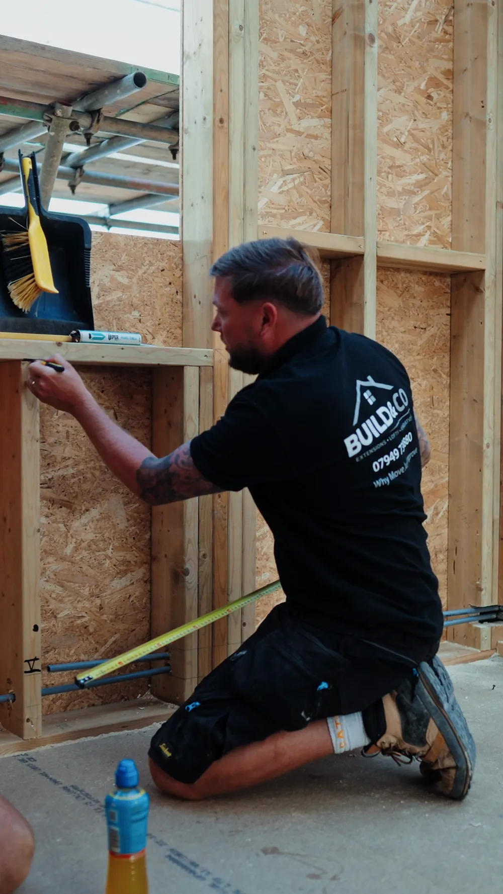 A carpenter measuring up on the first floor