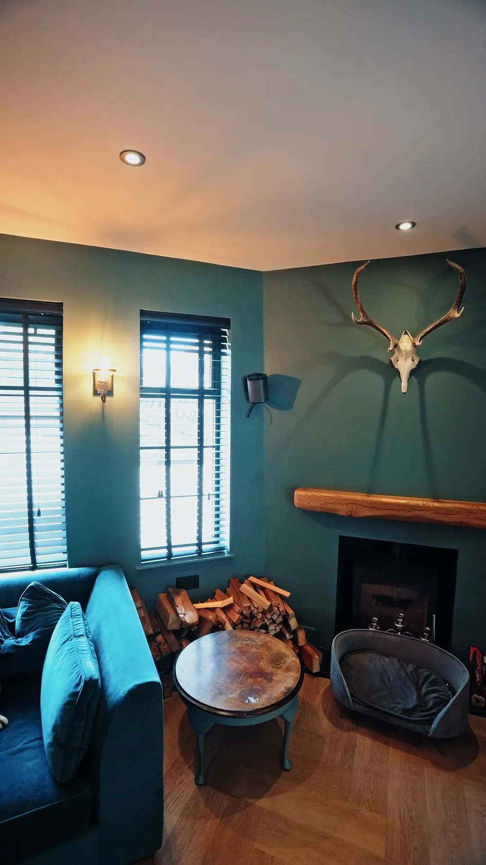 A dark green snug with a fireplace